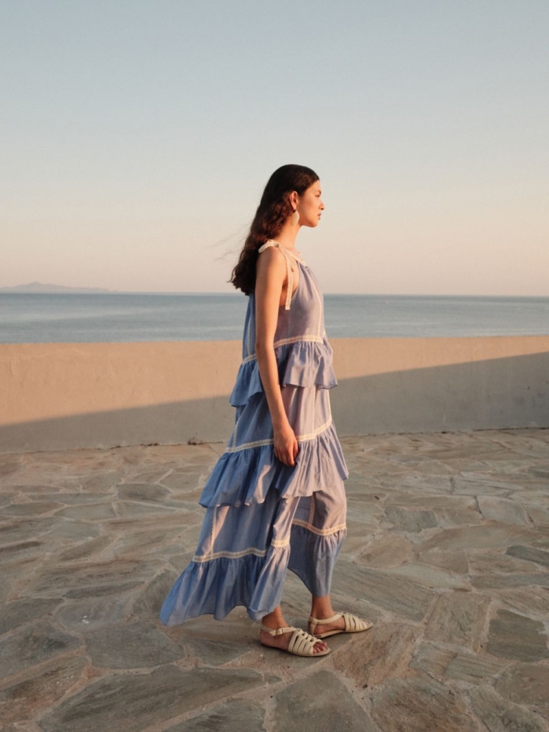 Woman wearing Devotion Twins Mirage dress in white cotton voile with lace details in a summer setting