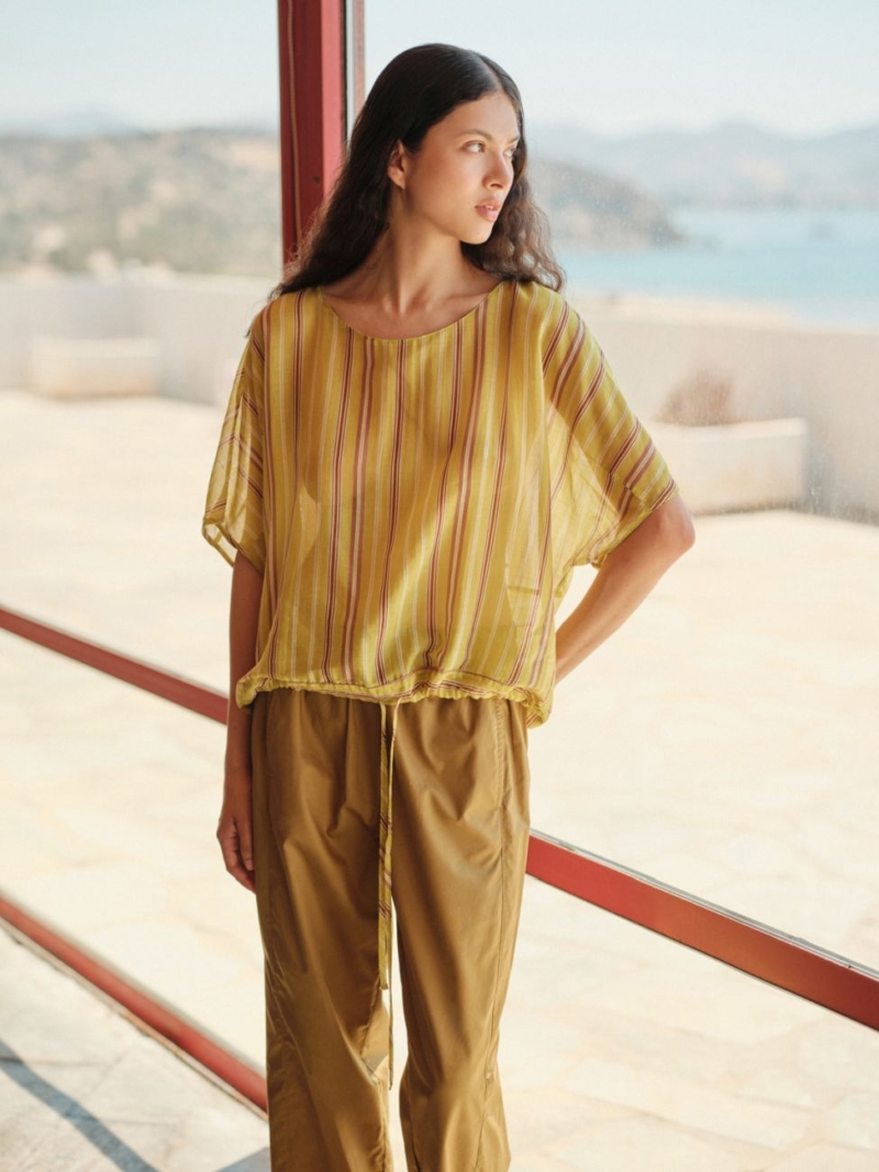 The Devotion Twins Seta Blouse Vivenza is a lightweight summer top with soft vertical stripes and a relaxed silhouette. Designed for effortless elegance,
