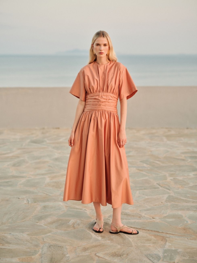 Shop the Devotion Twins Essence Dress – elegant poplin midi dress with cinched waist in black & dark orange. Perfect for summer, resort wear & chic day-to-night style.
